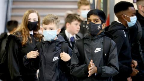 Schoolchildren wearing masks