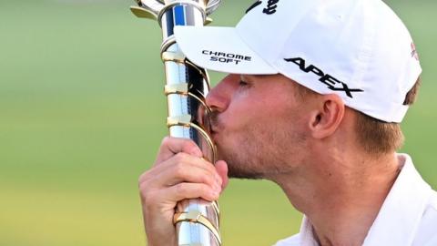 Nicolai Hojgaard kisses the trophy after winning the DP World Tour Championship