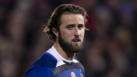 Tom de Glanville stands on the pitch during a Bath game