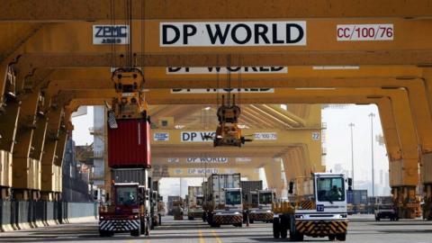 Terminal tractors line up to load containers into a cargo ship at DP World’s Terminal 2 at Jebel Ali Port in Dubai, August 2021