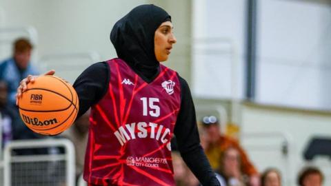 Rehana Khalil dribbling a basketball