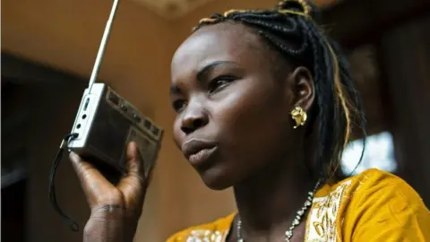 An athlete in South Sudan listening to the radio, March 2016