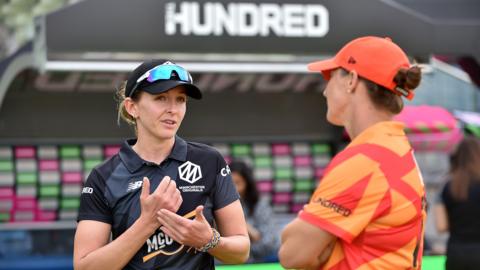 Former Manchester Originals captain Kate Cross speaks to Birmingham Phoenix's Sophie Devine ahead of the toss in The Hundred women's competition