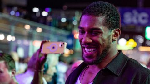 Anthony Joshua smiles broadly