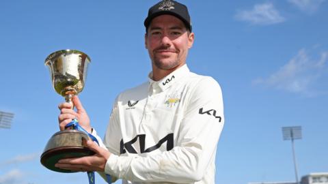 Surrey captain Rory Burns with the County Championship trophy