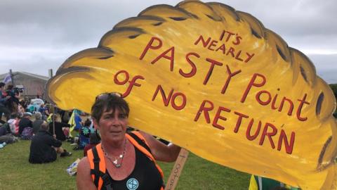 Protesters holding pasty sign saying 'it's nearly pasty the point of no return'