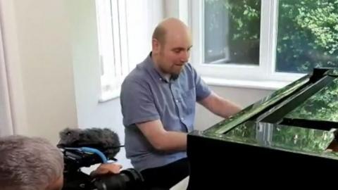 Matthew Richards playing the piano