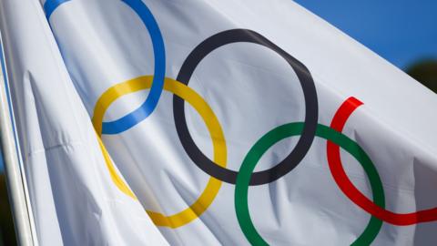 A flag featuring the Olympic rings