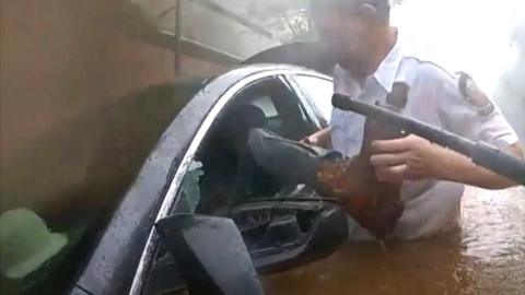Police freeing man stuck in car