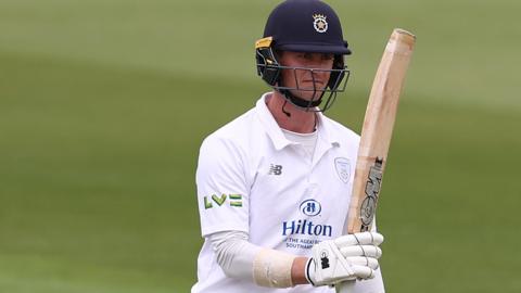 Hampshire batter Nick Gubbins rasises his bat after reaching a half-century