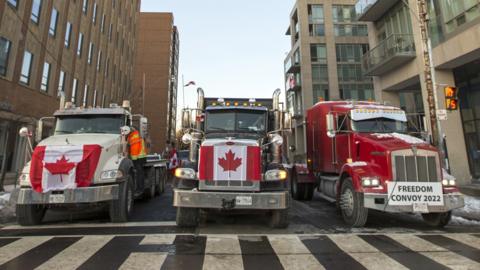 Trucks close off a street at Bloor Street West, Toronto.