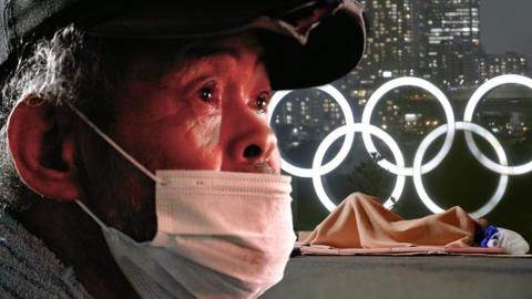 Homeless man in front of Olympic rings