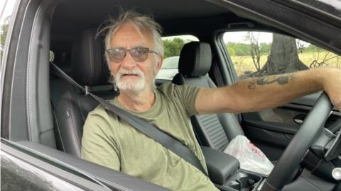 Keith Gant behind the wheel of a Land Rover