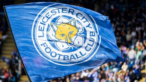 A Leicester City flag being waves at their home ground