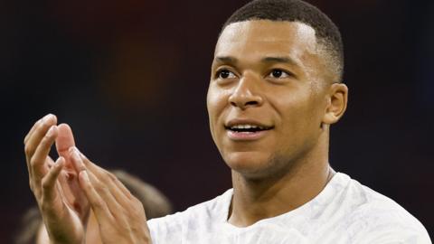 Kylian Mbappe celebrates France's win and claps towards the fans