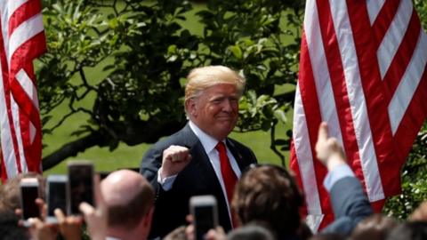 Trump pumps his fist as he departs the celebration