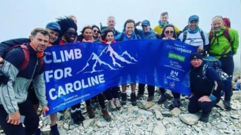 The Climb For Caroline team at the top of a peak