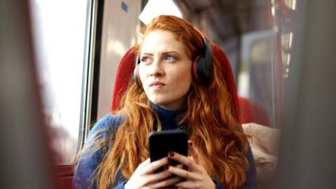 Woman looking concerned on train