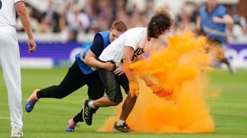 Just Stop Oil protester Jacob Bourne is grabbed by security