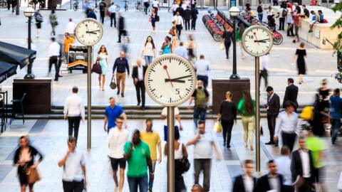 People walking across Canary Wharf