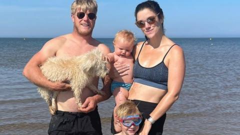 Katy Hancock with her husband Ed and children Dylan and Taylor at a beach