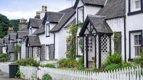 Row of white houses in the village Kenmore, Perth and Kinross, Perthshire in the Highlands of Scotland