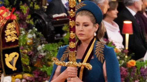 Penny Mordaunt holding the sword at the Coronation