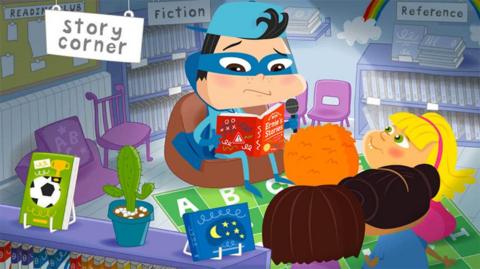 Cartoon character Ernie in story corner in a library reading a book to a small group of children.