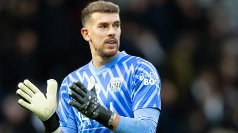 West Brom goalkeeper Alex Palmer claps the fans after a game