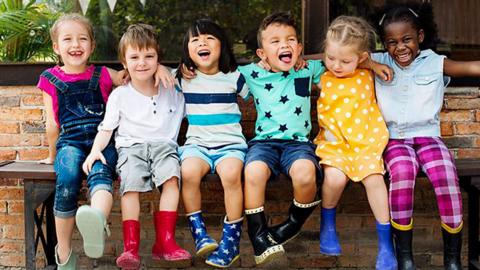 A group of smiling kids in wellies