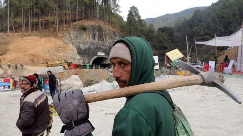 A worker arrives at the site of the Silkyara tunnel that collapsed while being under construction, to join in rescue operations, in Uttarkashi, India, 27 November 2023.