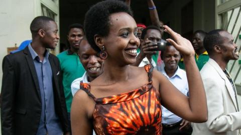 Diane Rwigara (front L), a critic of Rwanda's President, reacts as she leaves the Kigali's High Court