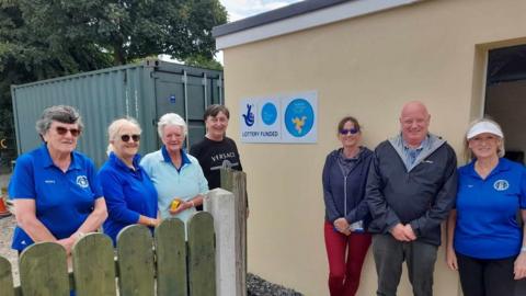 South Ramsey Bowling Club members next to the new storage facility