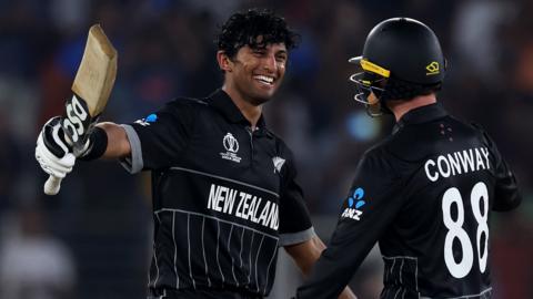 New Zealand batters Rachin Ravindra (left) and Devon Conway (right) embrace after both hit centuries