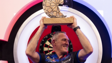 Neil Duff celebrates with the WDF World Championship trophy