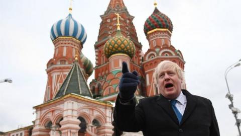 Boris Johnson stands in front of Saint Basil"s cathedral in Red square in Moscow