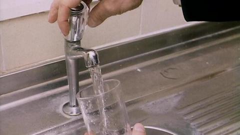 Filling glass of water
