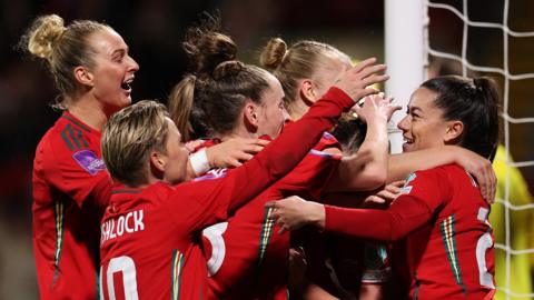 Wales players celebrate Angharad James' goal