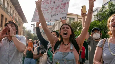 Pro-Palestinian students chant as they protest the Israel-Hamas war on the campus of the University of Texas in Austin, Texas, on 24 April 2024