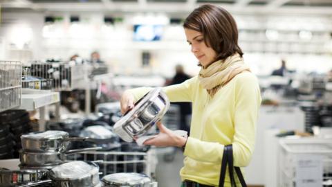Woman shopping for kitchen pans