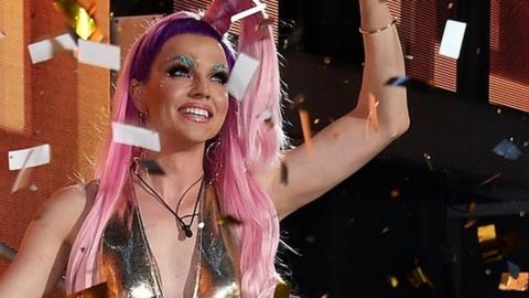 Courtney Act waving to the crowd after winning Celebrity Big Brother