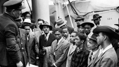Image showing Jamaican migrants being welcomed by RAF officials as they disembarked the Empire Windrush