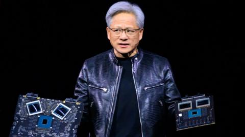 Nvidia's CEO Jensen Huang displays products on-stage during the annual Nvidia GTC Artificial Intelligence Conference.