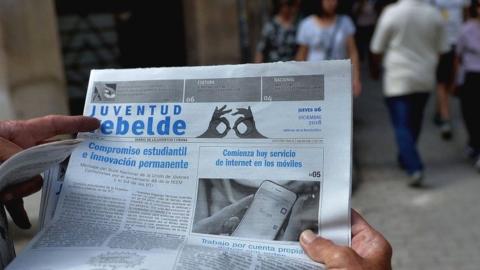 A man reads a newspaper in Havana