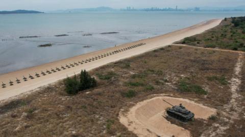File photo of a retired military tank is seen on the beach with China in the background in Kinmen, Taiwan