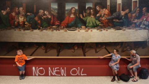 Protesters from Just Stop Oil climate protest group glue their hands to the frame of a copy of Leonardo da Vinci's, The Last Supper inside the Royal Academy, London.