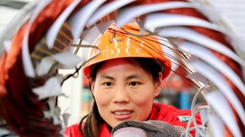 An employee works at a permanent magnet motor workshop of Shengli Oilfield Shuntian Energy Saving Technology