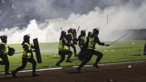 Tear gas is fired as police try to stop fans from entering the pitch in Malang, Indonesia. Photo: 1 October 2022