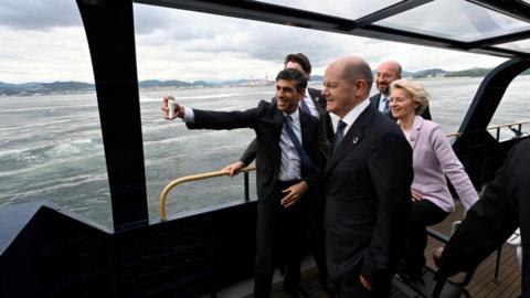 Rishi Sunak taking a selfie on a boat with other world leaders at the G7