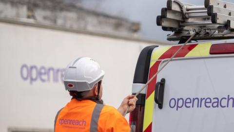 An Openreach engineer loading a van